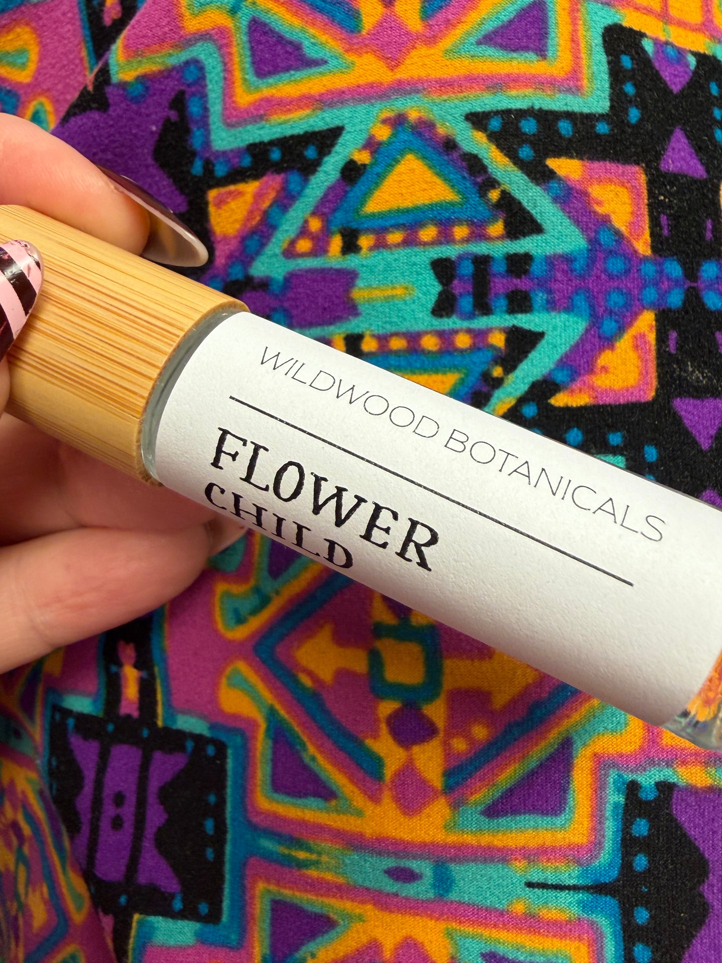 Wildwood Botanicals rollerball perfume bottle with clear glass and elegant label, showcasing a natural floral fragrance.
