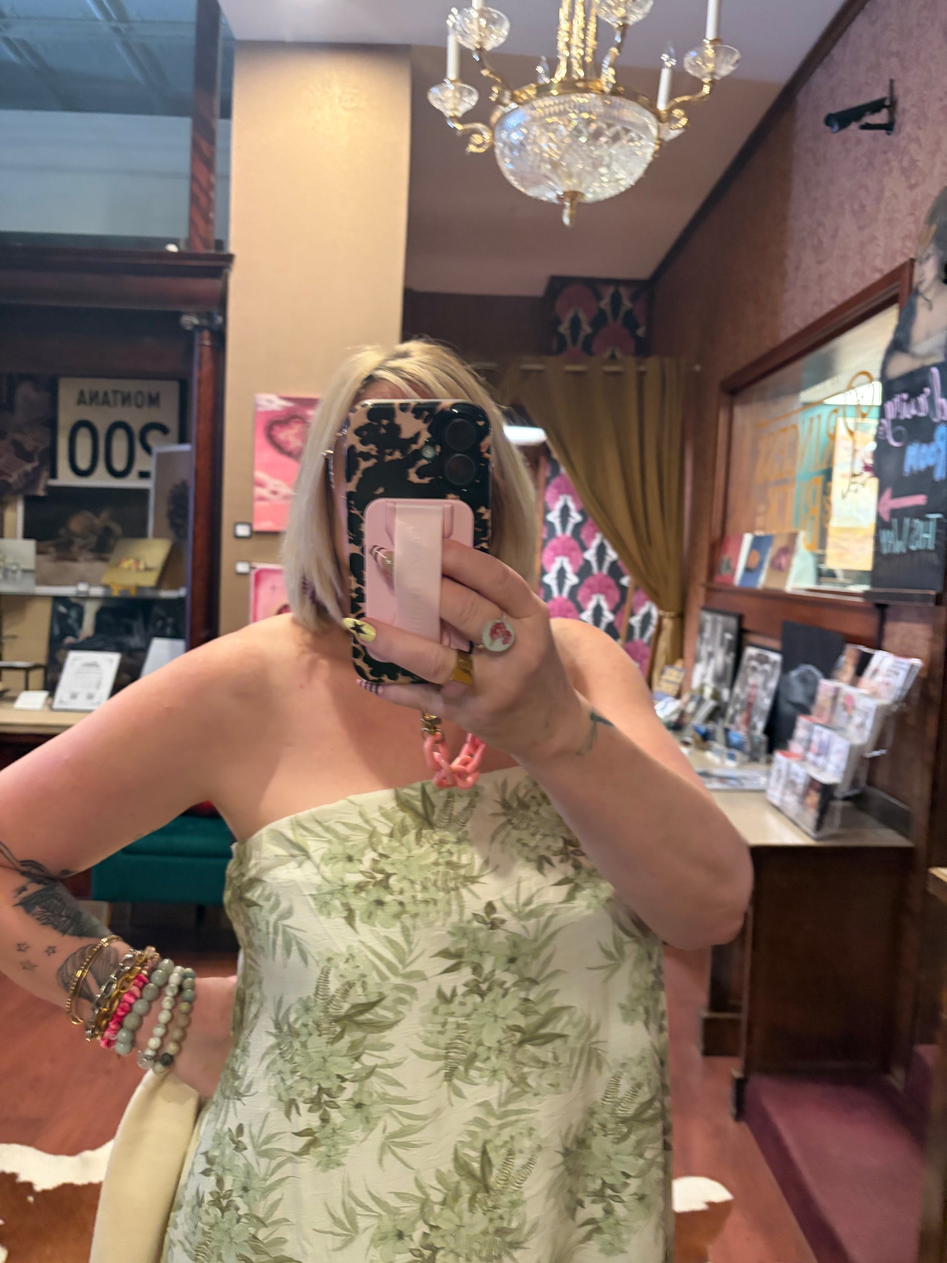 Princess & Buck Fern Gully Dress shown on a hanger with floral patterns and flowing fabric, perfect for casual or summer wear.