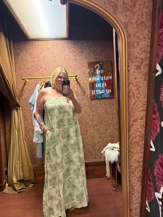 Princess & Buck Fern Gully Dress displayed on a hanger with floral patterns and flowing fabric, perfect for casual or summer wear.