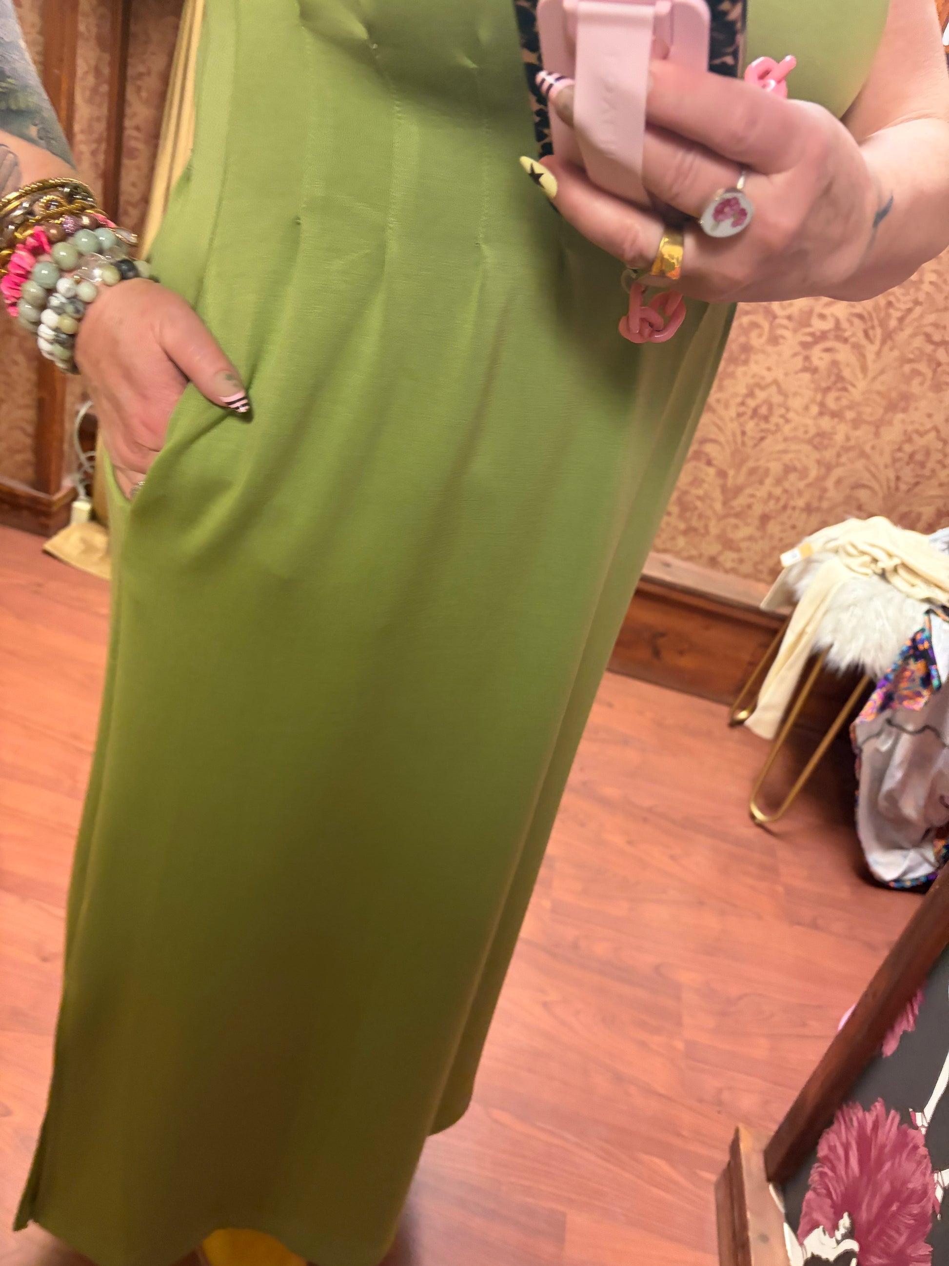 Entro Matcha Dress showing a stylish green sleeveless dress with a fitted waist and flowy skirt on a model.