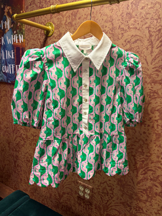 Entro Mod Floral Blouse with vibrant flower pattern, lightweight fabric, and relaxed fit, shown on a hanger.