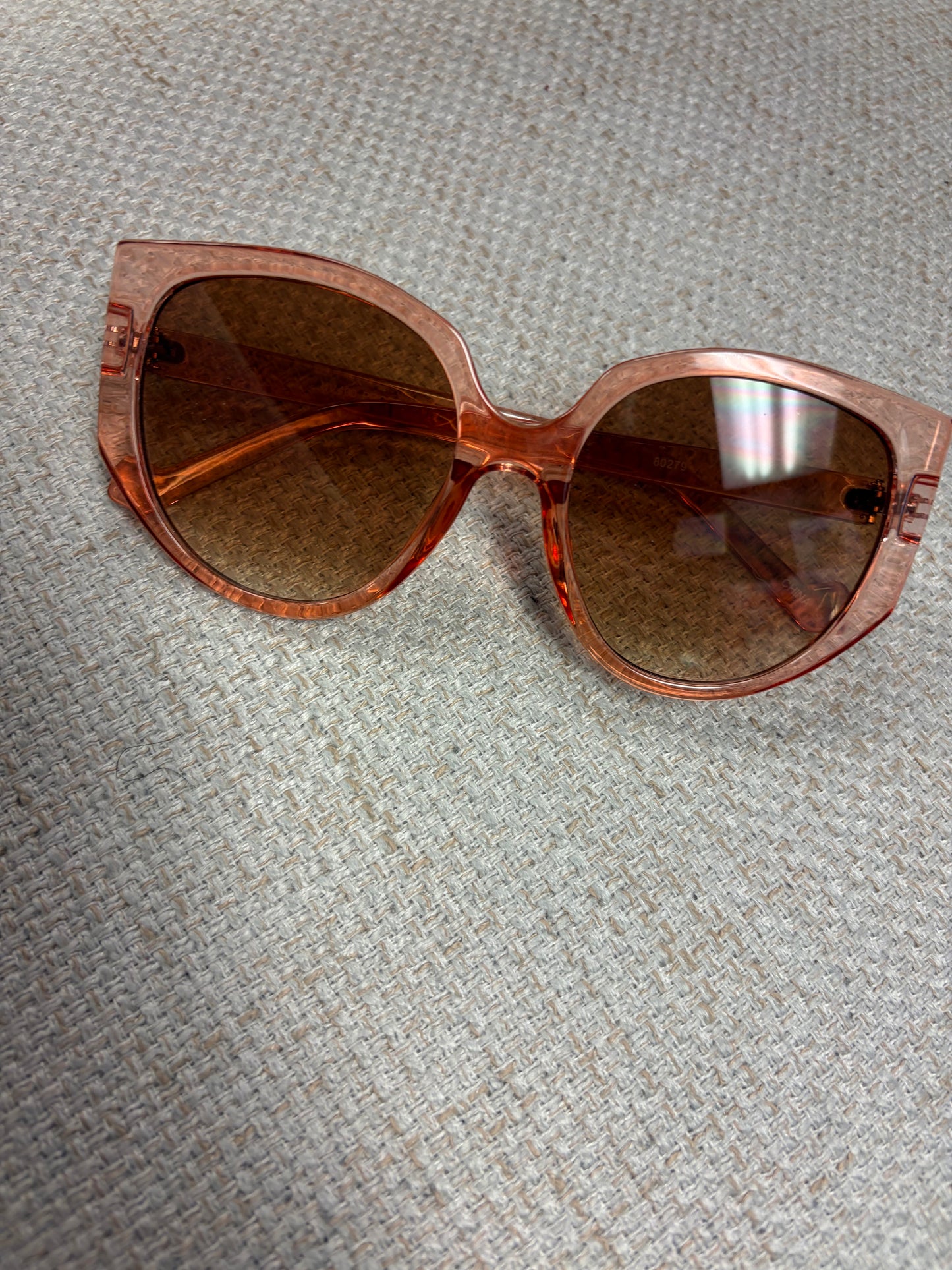 A pair of Tangerine Dream sunglasses by A Sparkling Mess with orange tinted lenses and stylish frame design.