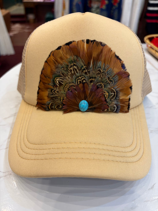 Queen Gypsy feather trucker hat with mesh back and curved brim, stylish casual headwear for outdoor wear.