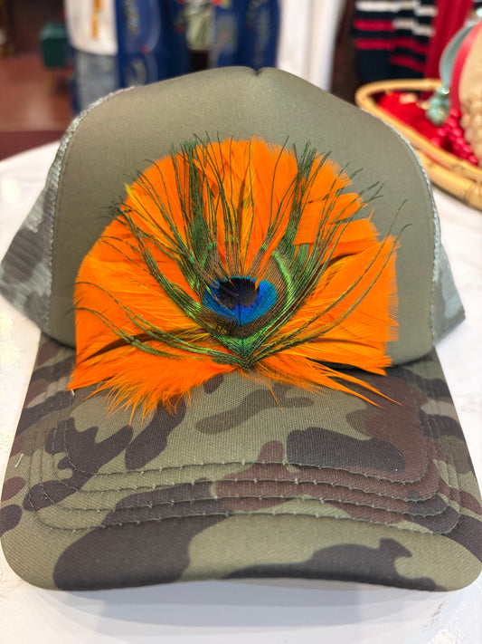 Queen Gypsy feather trucker hat with mesh back and curved brim, stylish casual accessory for outdoor wear.