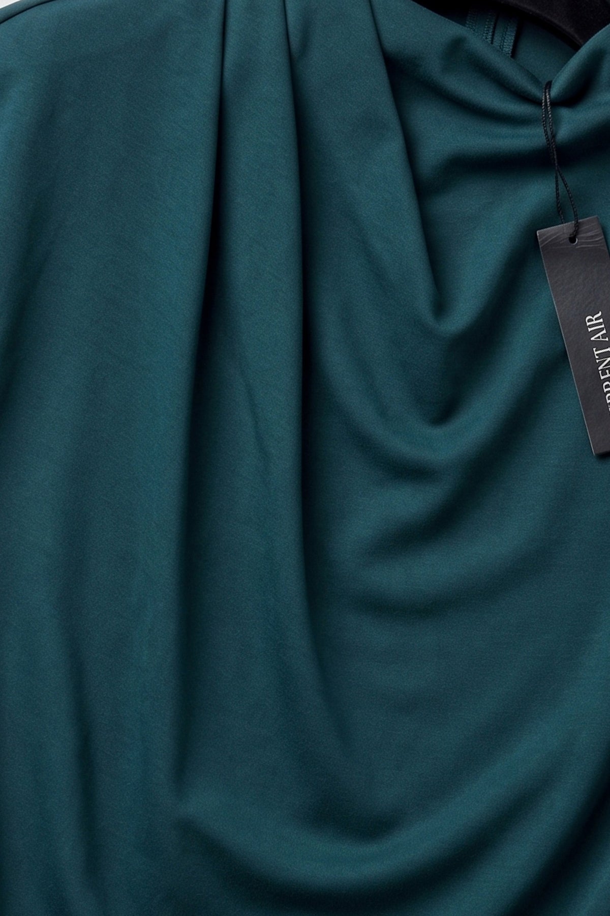 Current Air Keepin’ It Teal Dress displayed on a hanger, showcasing its lightweight fabric and stylish sleeveless design.
