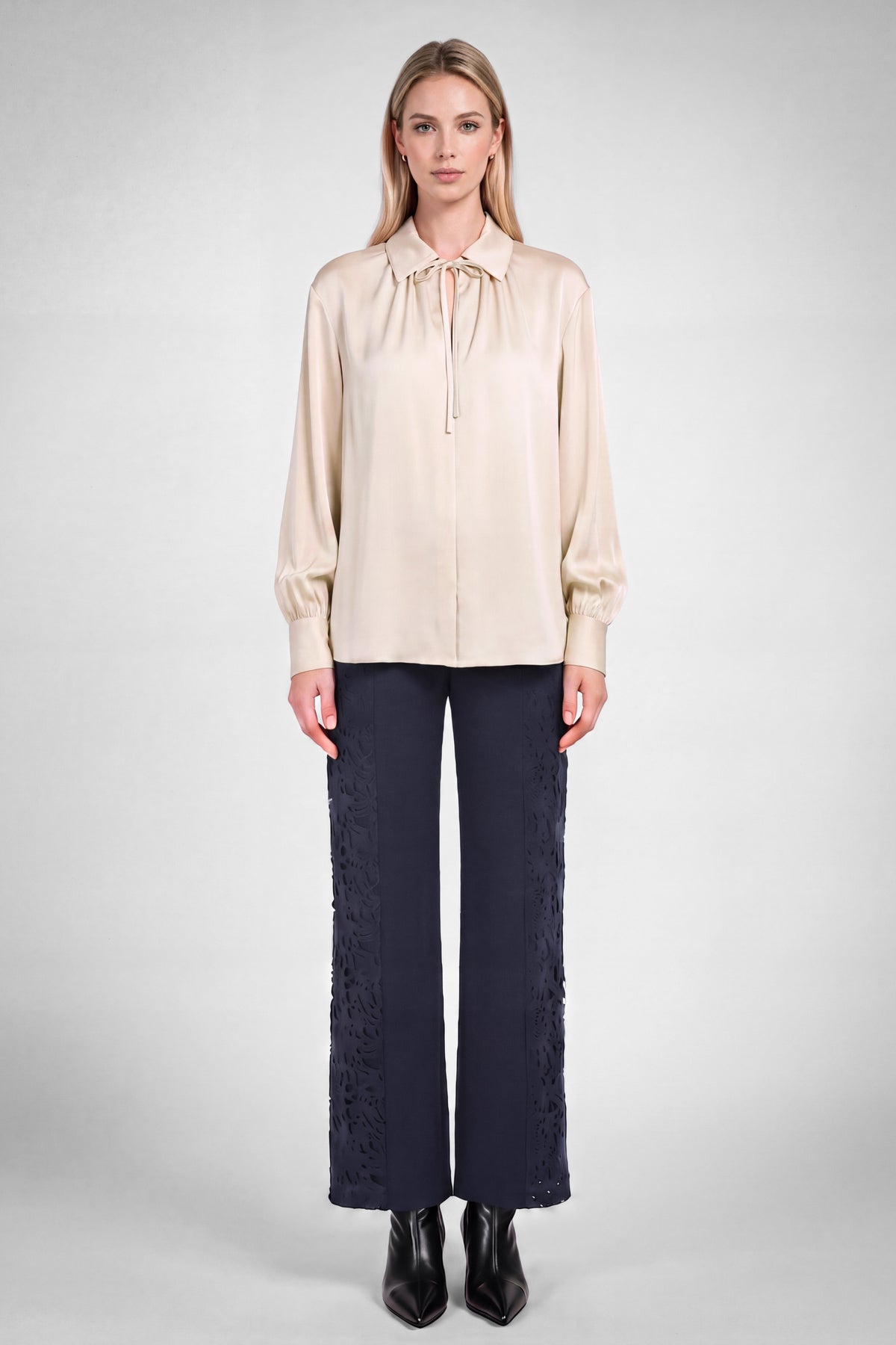 Ecru front tie silky blouse by Current Air displayed on a hanger with smooth fabric and front tie detail.