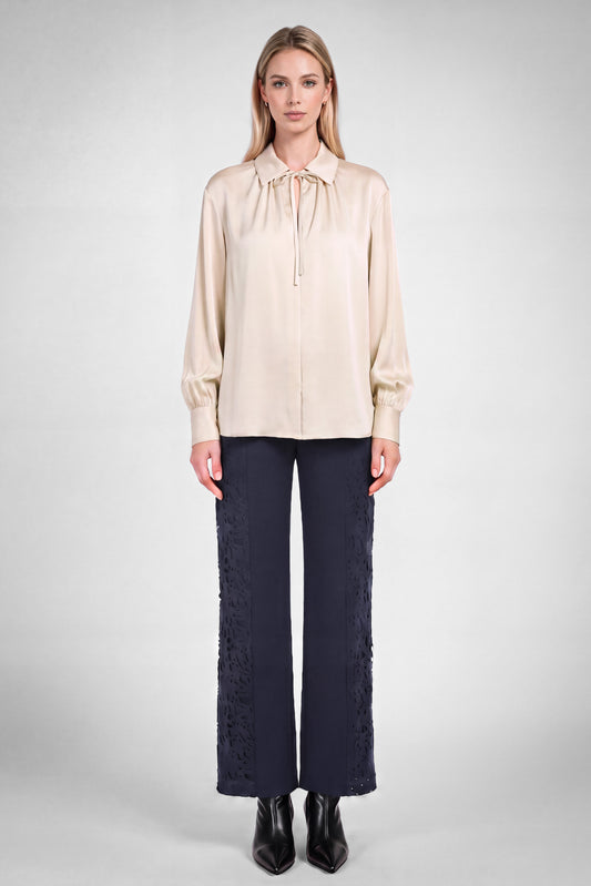 Ecru front tie silky blouse by Current Air displayed on a hanger with smooth fabric and front tie detail.