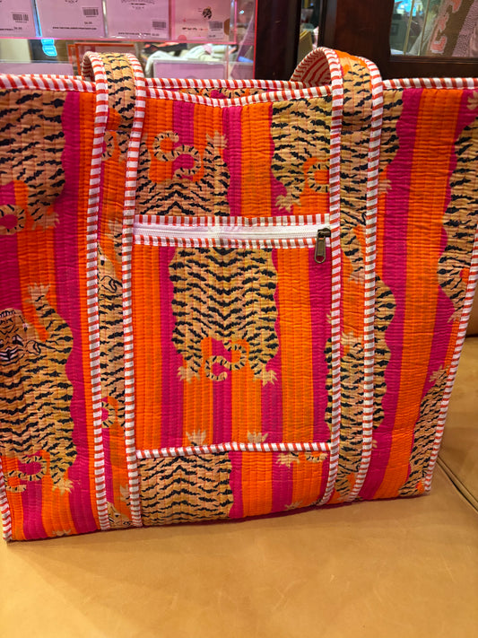 Pink and orange tiger print tote bag from The Roots, featuring a spacious design and sturdy handles.