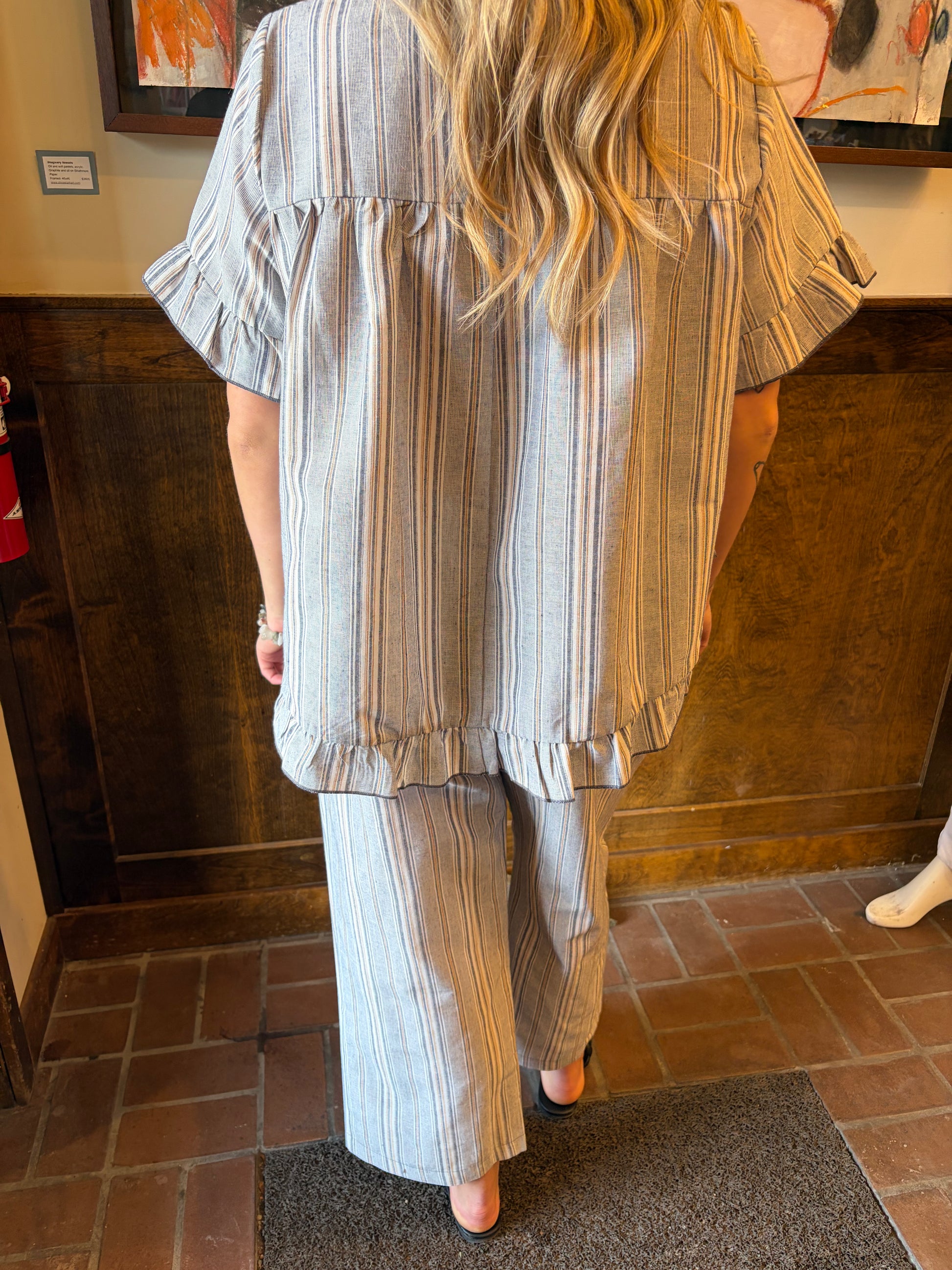Camille & Co. Earn Your Stripes Pants, stylish striped bottoms with a comfortable fit, displayed on a hanger.
