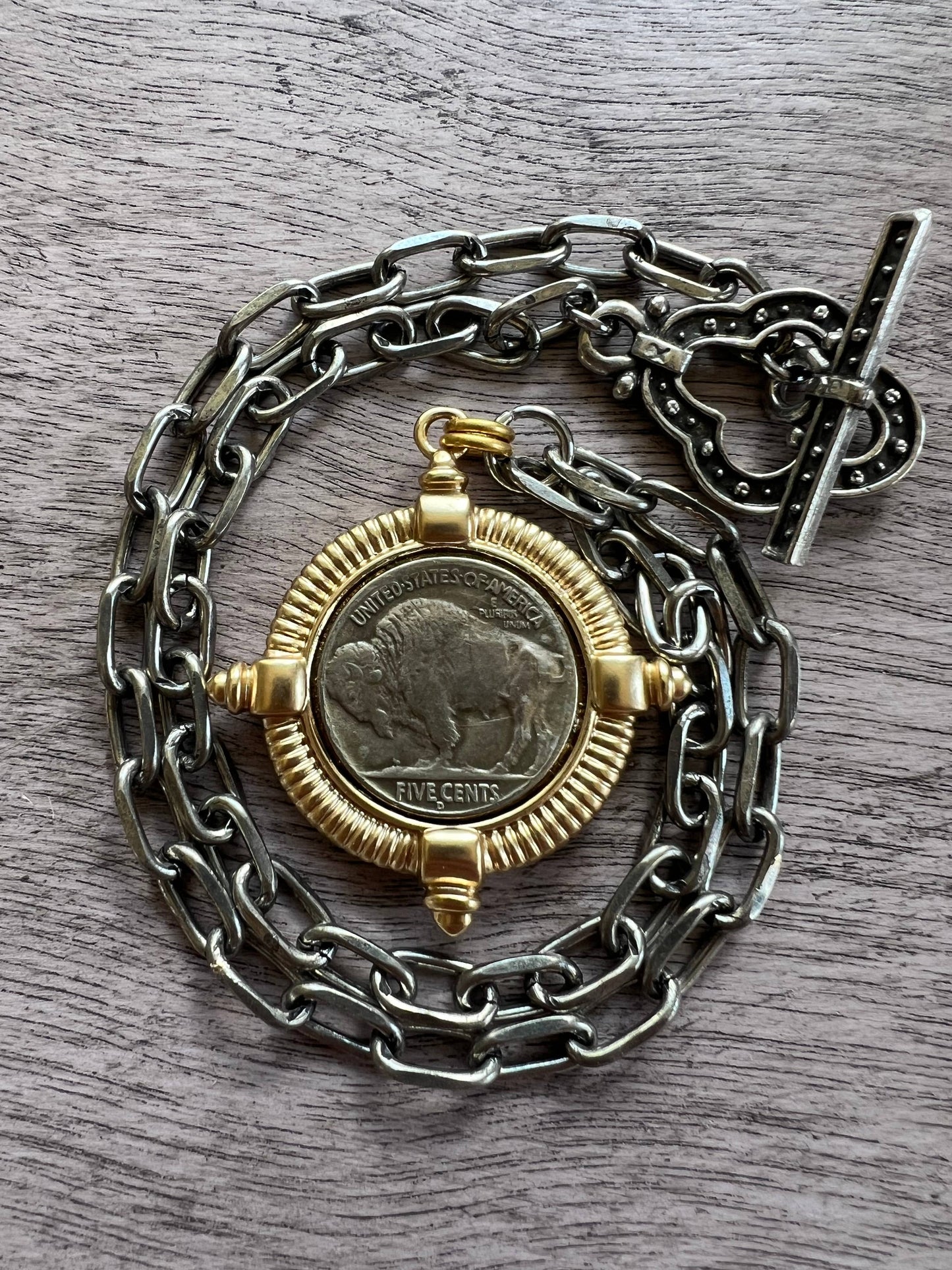 Chasing Cherubs Buffalo necklace featuring a detailed metallic buffalo pendant on a chain, stylish jewelry accessory.