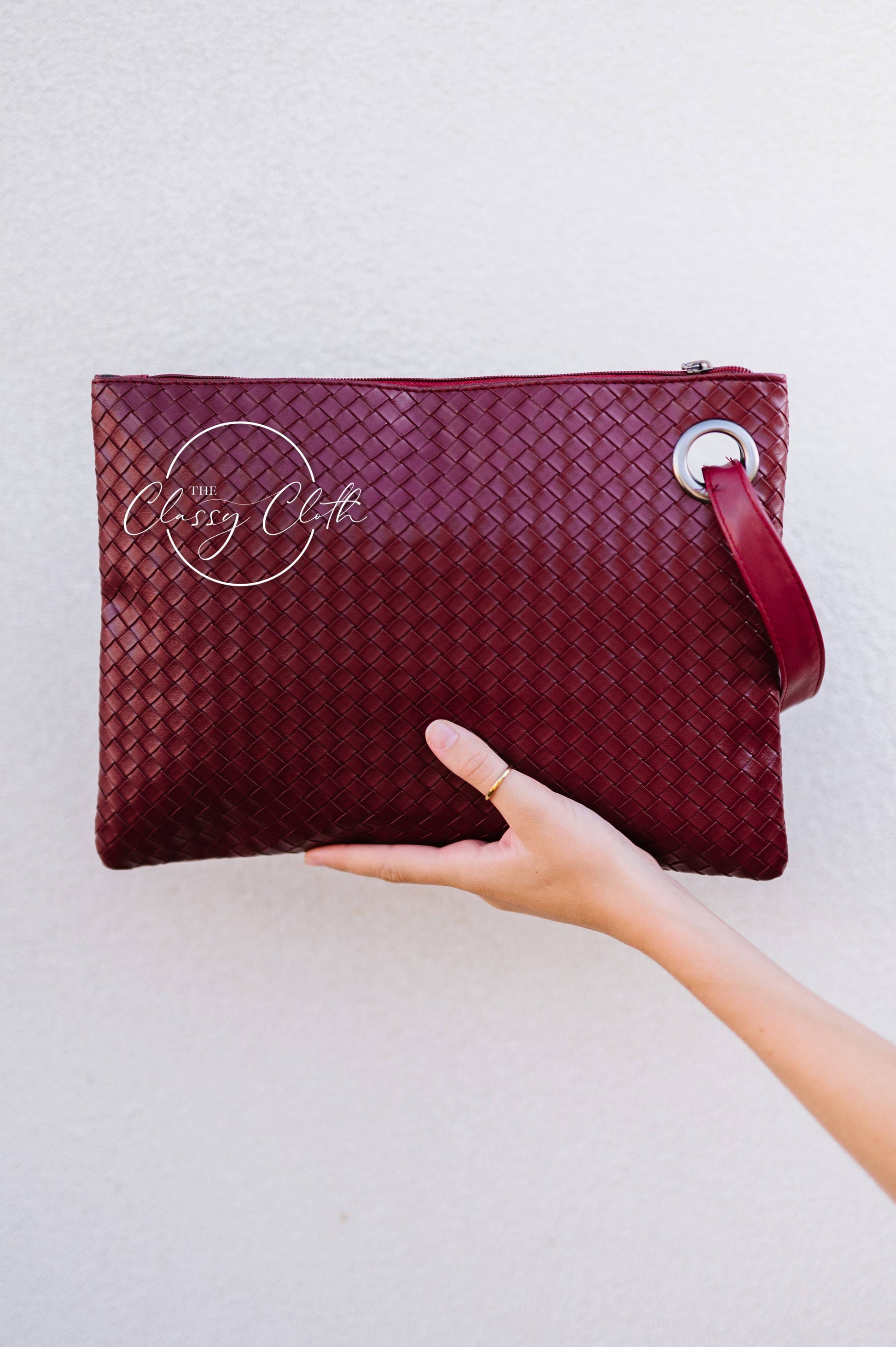 Trendy Weave Wine RTS clutch bag by The Classy Cloth WS featuring a woven design and compact style for versatile occasions.