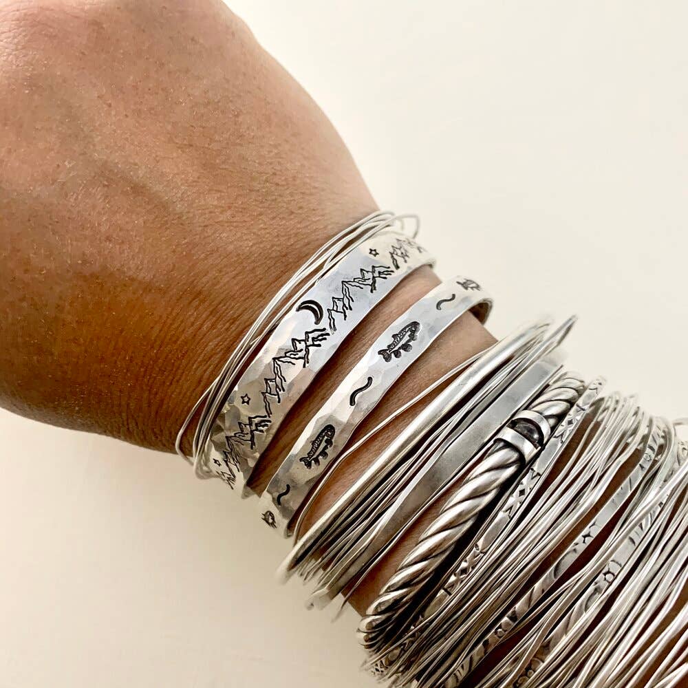 Handmade Mountain High Cuff bracelet by Fluff Hardware featuring a textured mountain design in metal.