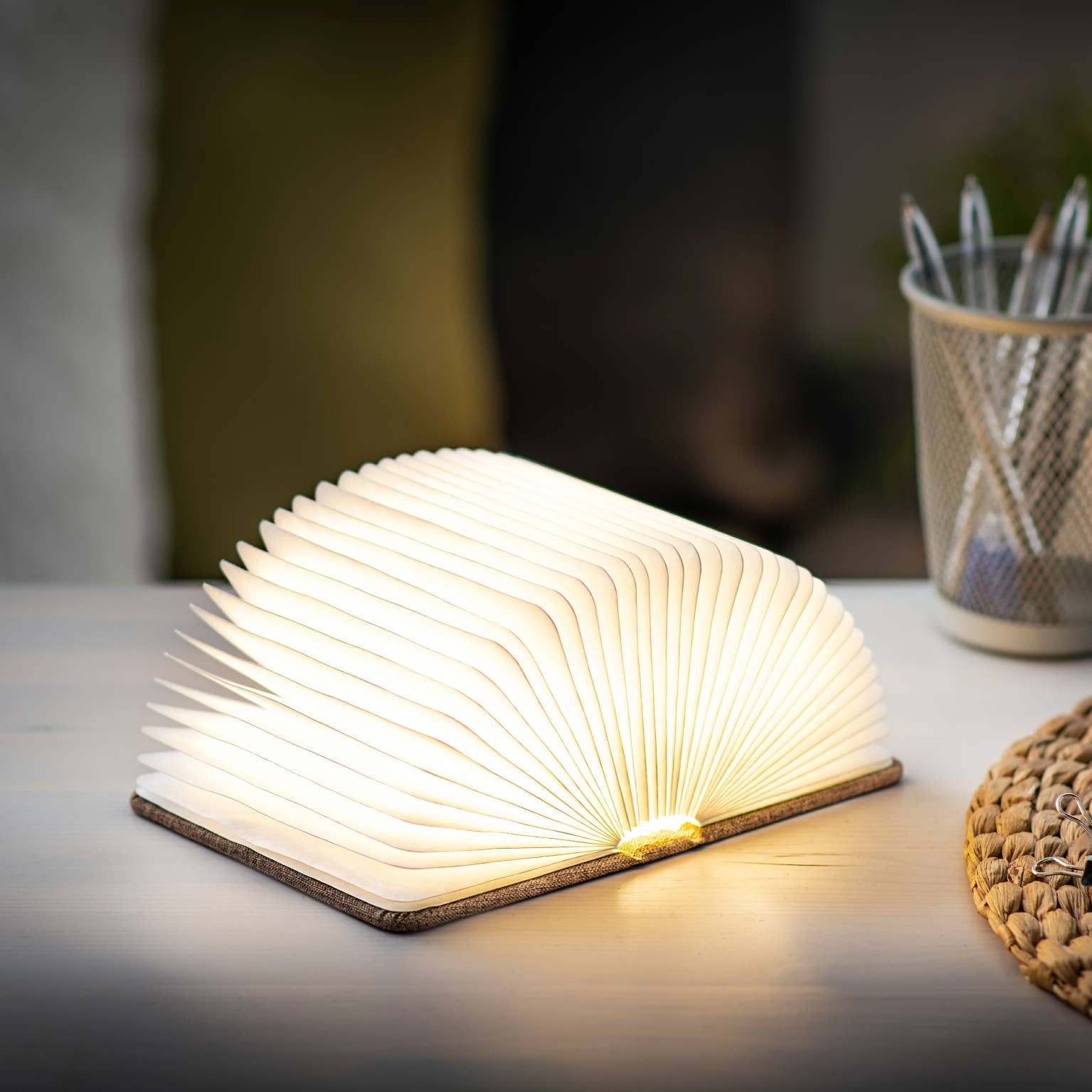 Gingko Design linen fabric smart book light with soft white LED illumination, featuring a sleek, modern lamp design for reading.