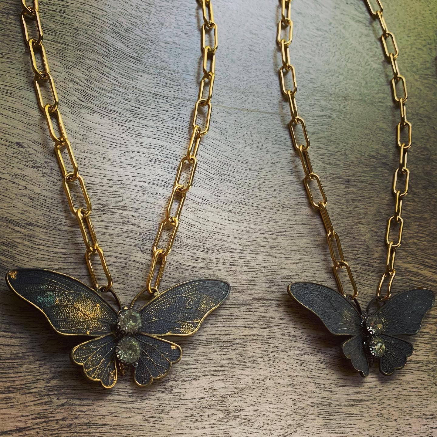 Chasing Cherubs Flutter necklace featuring a delicate pendant with intricate design on a fine chain.