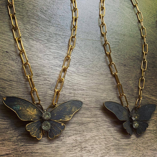 Chasing Cherubs Flutter necklace featuring a delicate pendant with intricate design on a fine chain.
