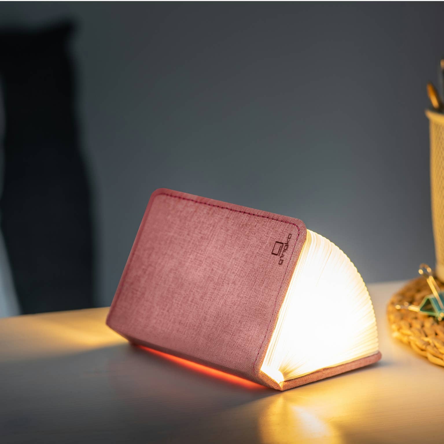 Gingko Design linen fabric smart book light lamp with soft illumination, designed for reading and ambient lighting.