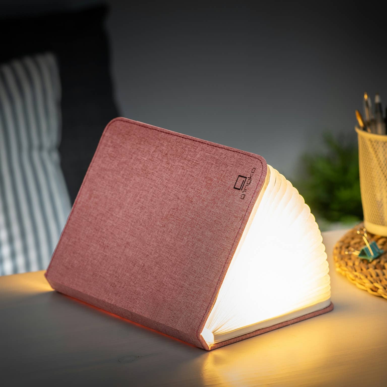 Gingko Design linen fabric smart book light lamp with soft fabric cover and adjustable LED light for reading and ambiance.