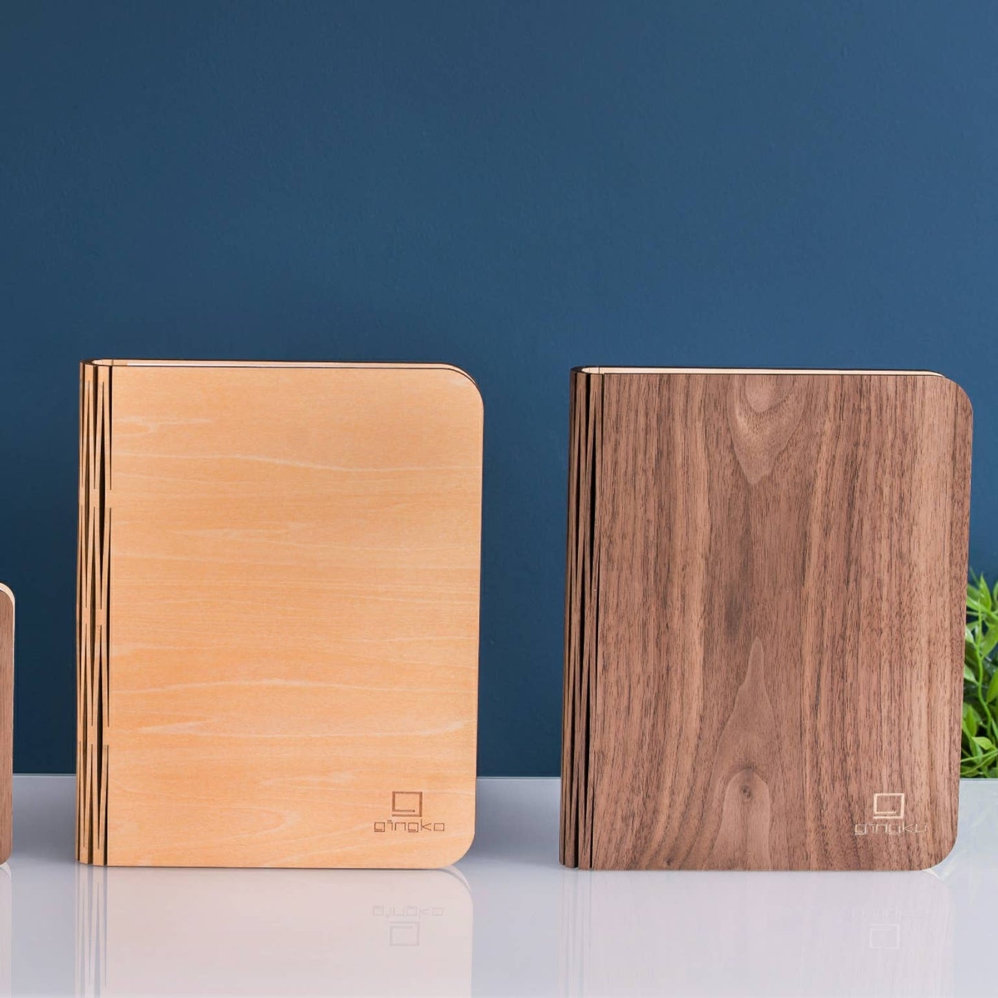 Natural wood smart book light by Gingko Design, featuring a sleek lamp with a wooden finish and adjustable reading light.