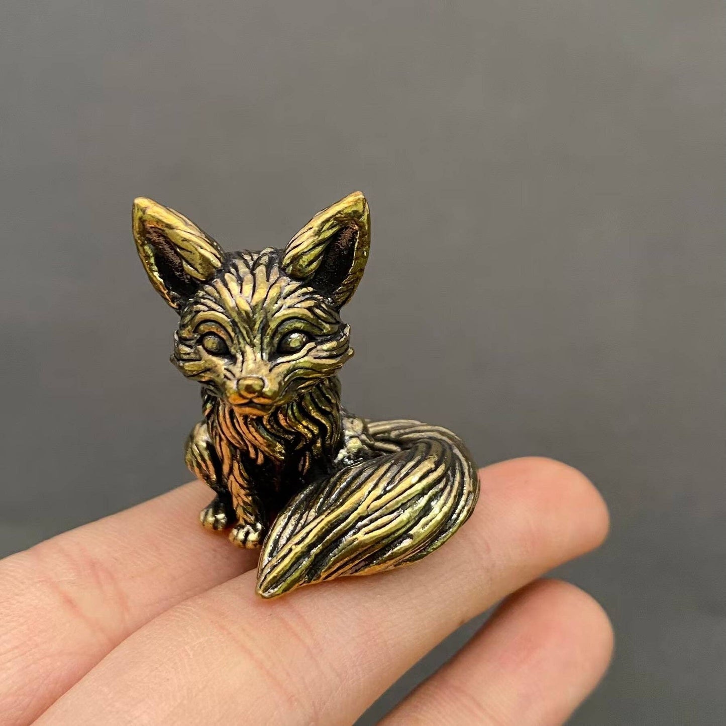 Brass Little Fox figurine from Mio Queena Delights, detailed small fox sculpture with a shiny finish, resting on a neutral background.