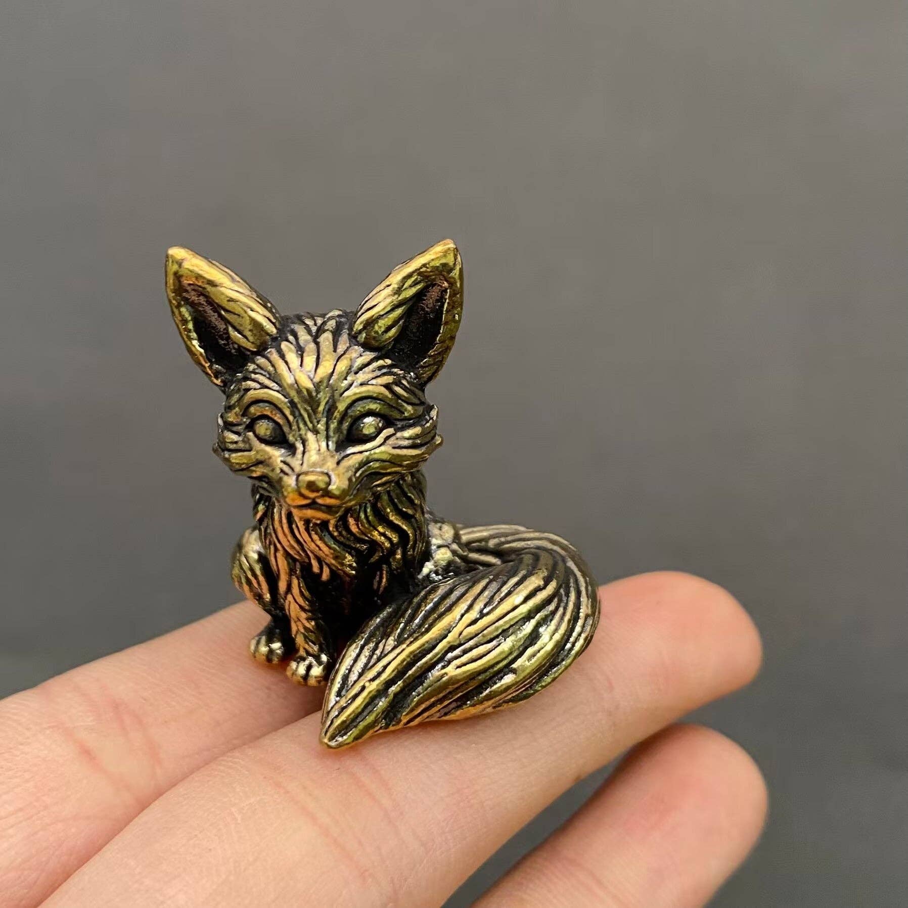 Brass Little Fox figurine from Mio Queena Delights, detailed small fox sculpture with a shiny finish, resting on a neutral background.