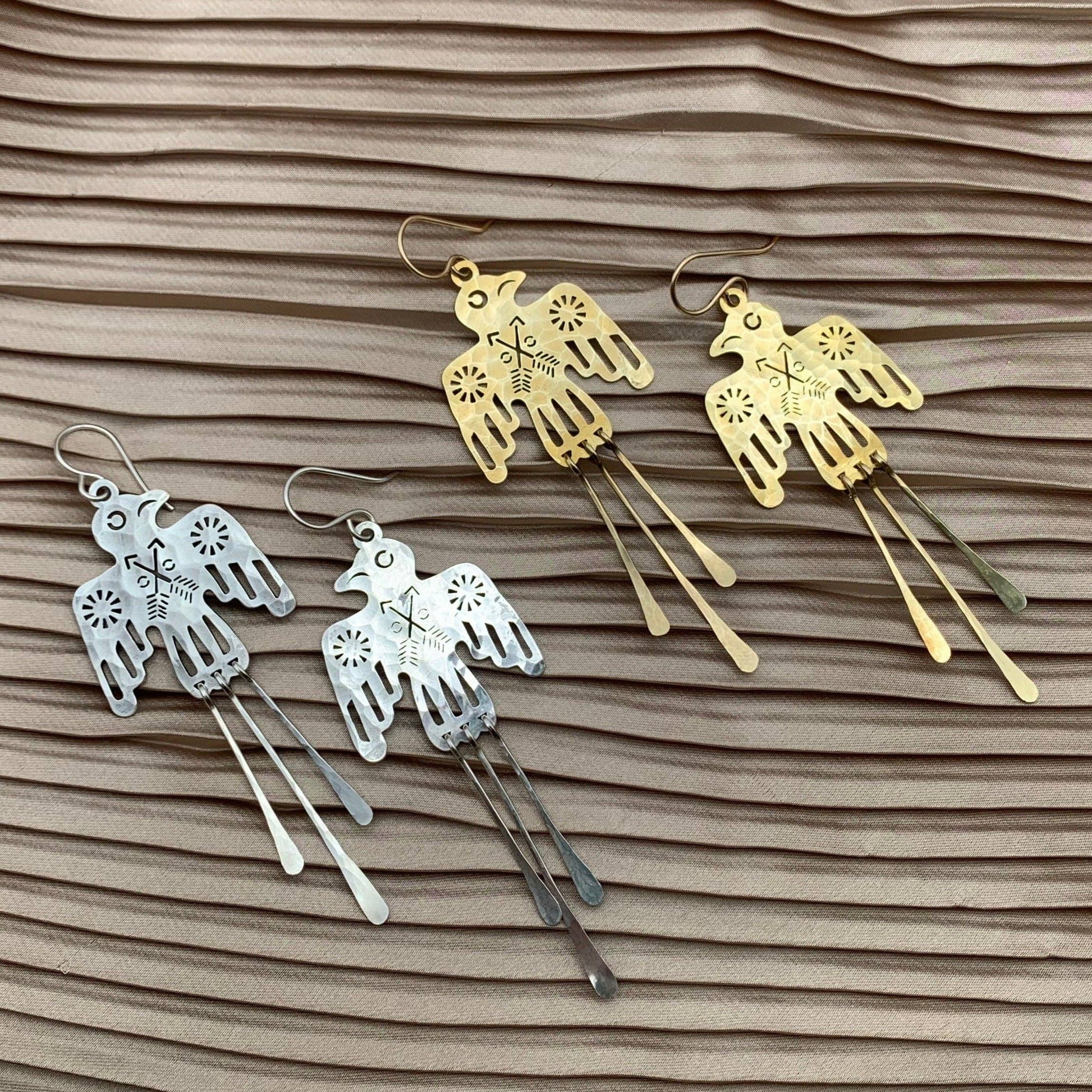 Silver Glide Earrings by Fluff Hardware featuring sleek, minimalist design with smooth, curved metal shapes.