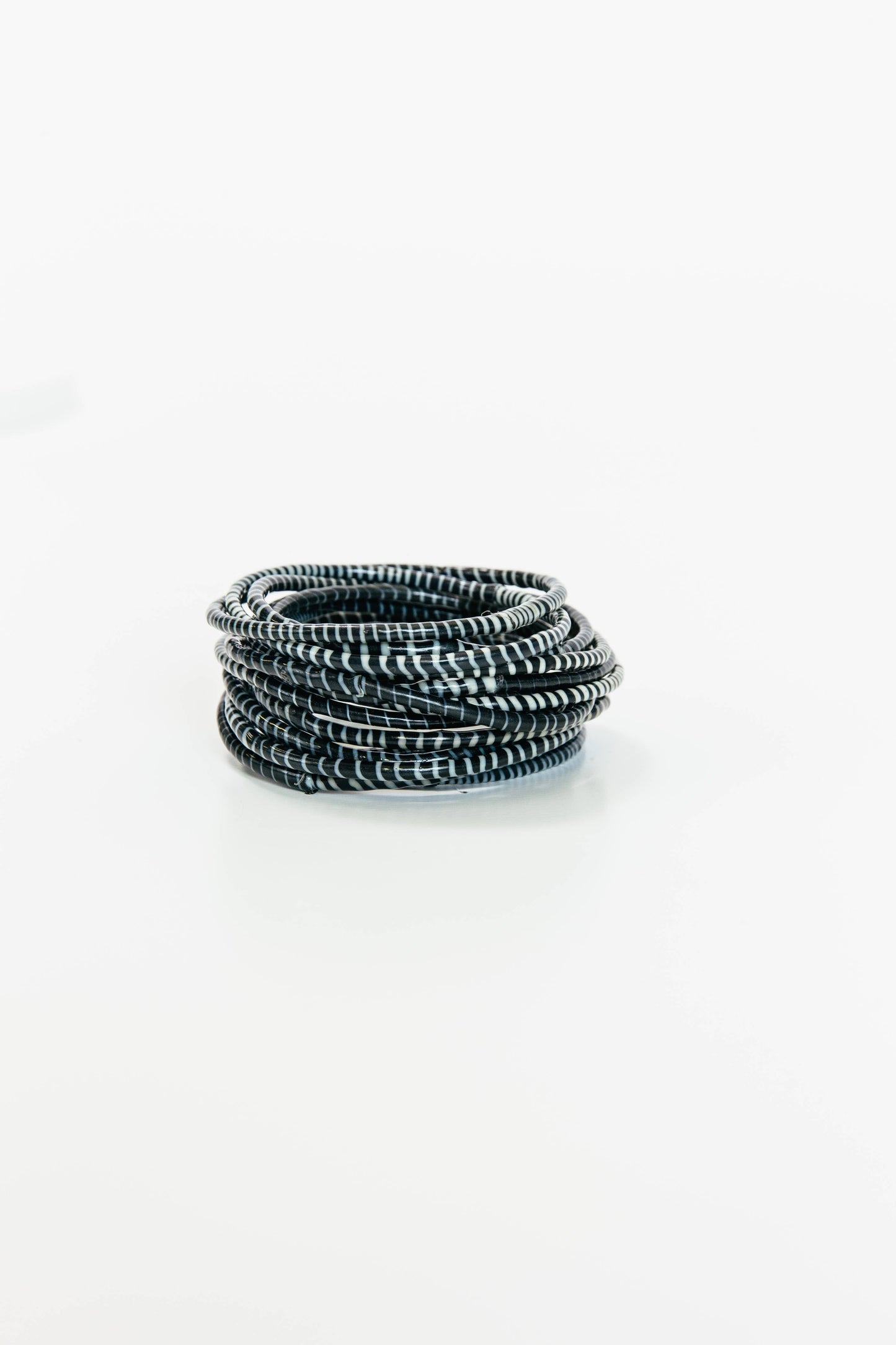 Black Beach Bangles bracelet by BECASA featuring multiple stylish bangles with textured and smooth finishes.