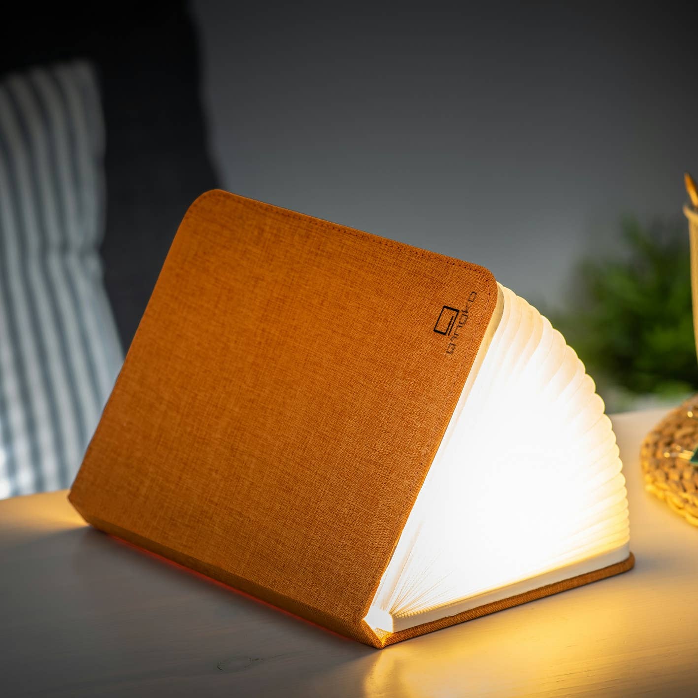 Gingko Design linen fabric smart book light with adjustable lamp arm and soft LED illumination, ideal for reading in bed.