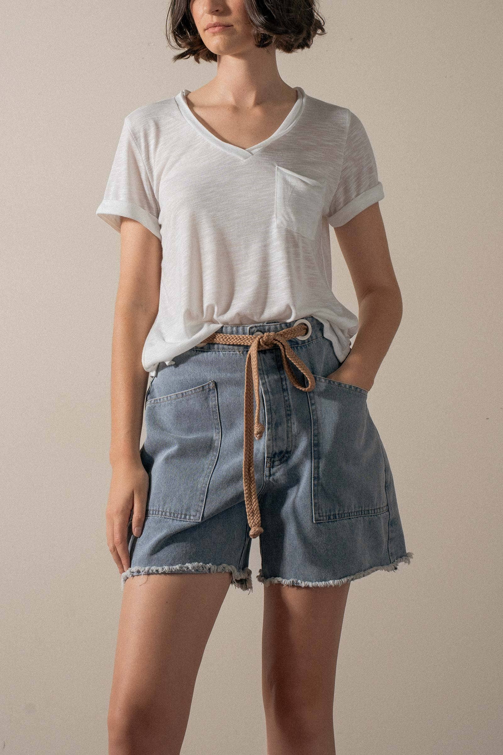 Urban Daizy high-waisted denim shorts with frayed hem, showcasing a casual, stylish summer look.