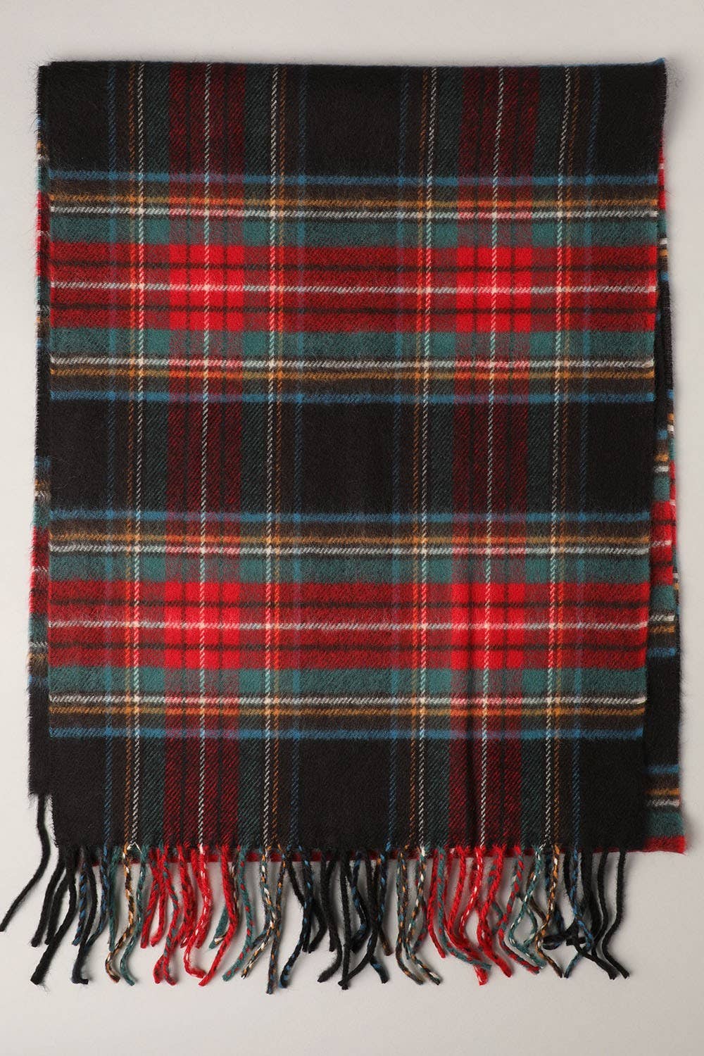 Fashion City tartan plaid muffler scarf with fringed edges, showcasing its cozy, stylish winter accessory in red and black tones.