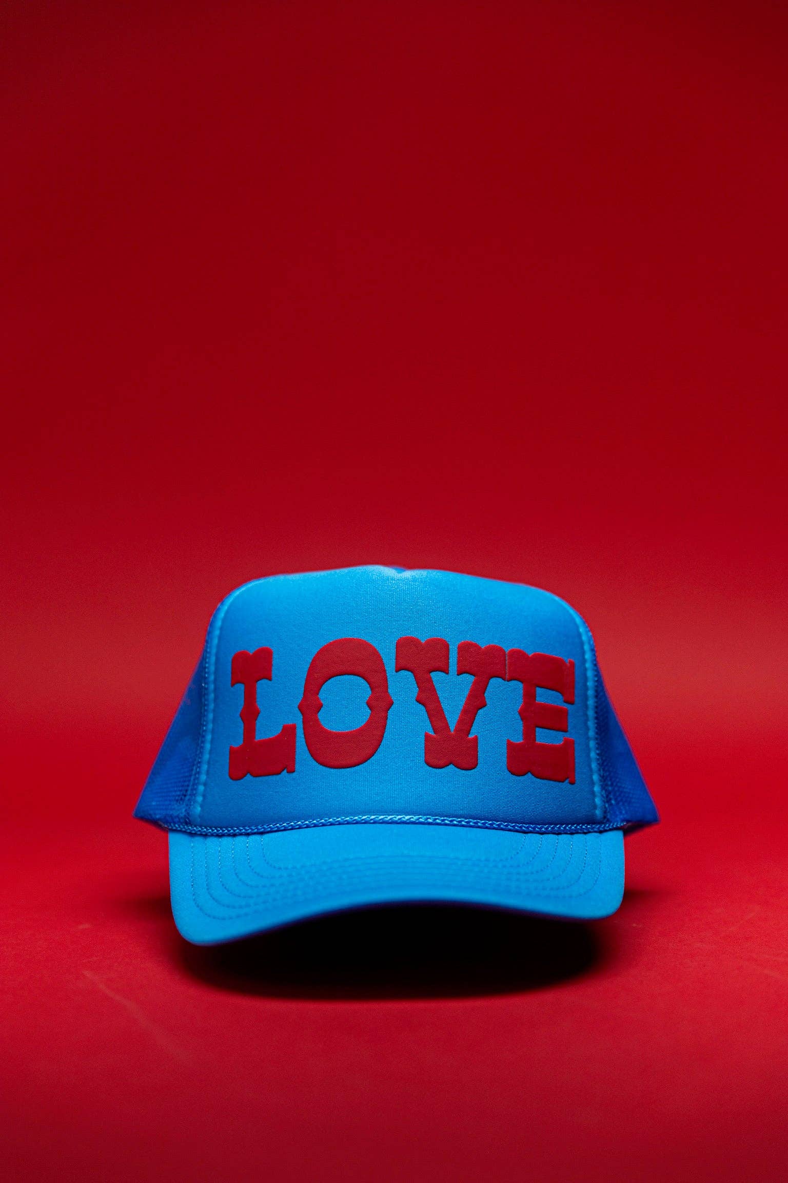 Ascot + Hart Big Love Trucker hat with a structured brim and adjustable strap, featuring bold embroidered "Big Love" design.