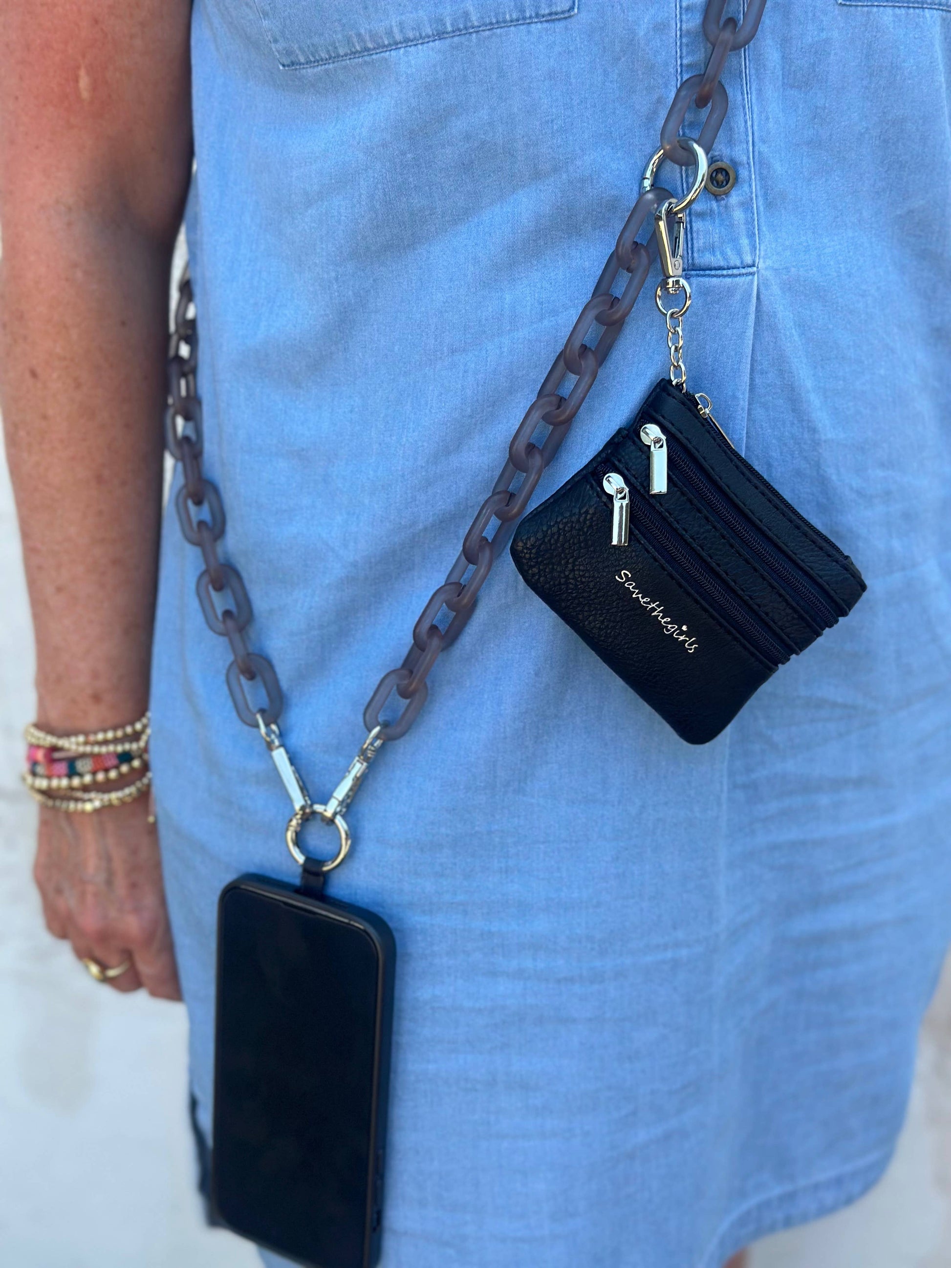 Save The Girls Clip & Go Ice Chain with pouch attached to a phone, featuring a clear plastic chain and compact pouch for convenience.