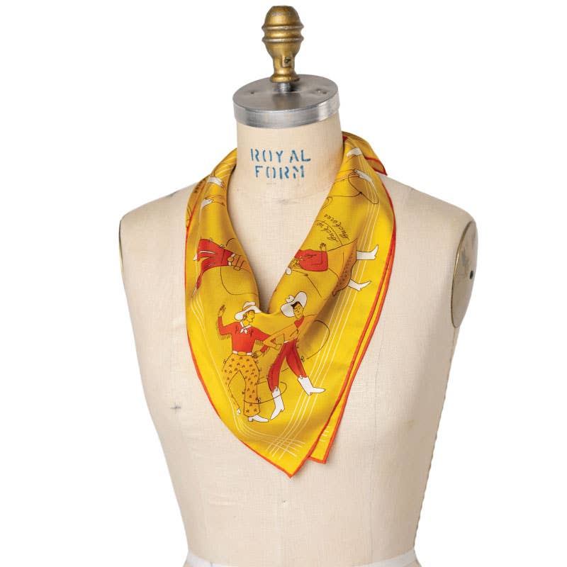 Jenni Earle Buck Up Buckaroo silk bandana scarf with vibrant western-inspired print, tied on display.