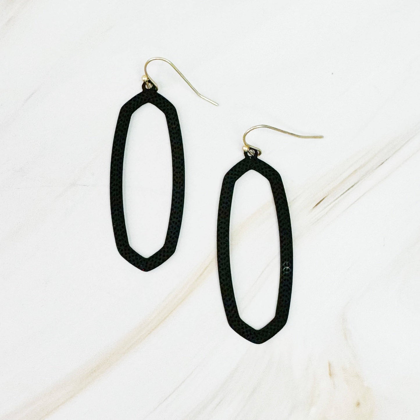 Ellison+Young Shape Of Game earrings featuring geometric, abstract design in gold-tone metal on a white background.