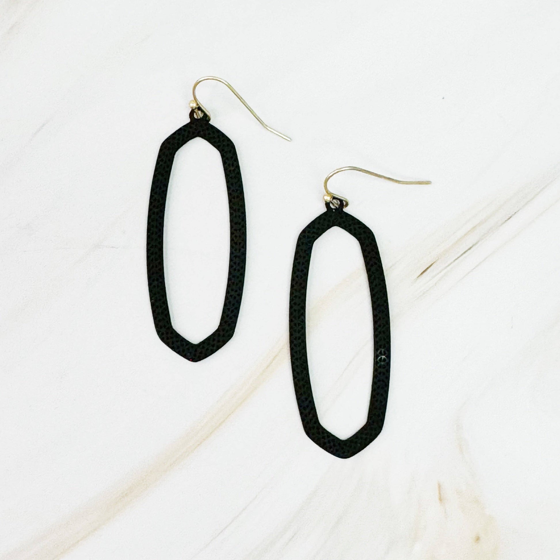 Ellison+Young Shape Of Game earrings featuring geometric, abstract design in gold-tone metal on a white background.