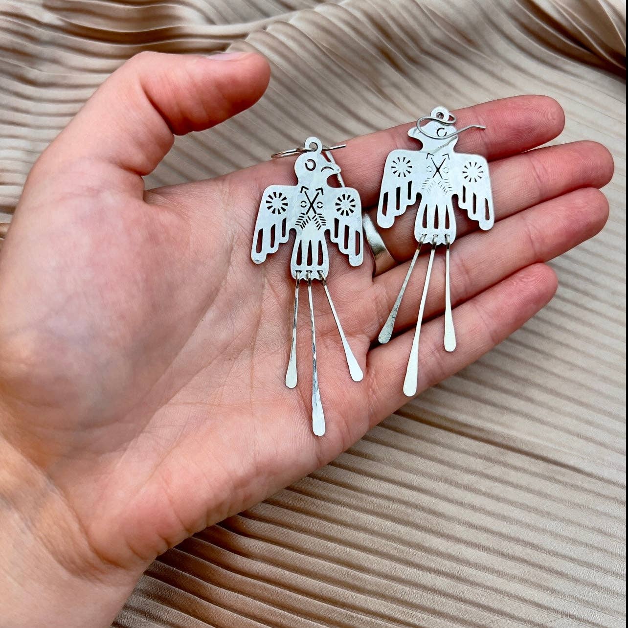 Pair of sleek silver Glide Earrings by Fluff Hardware featuring minimalist hoop design and smooth finish.