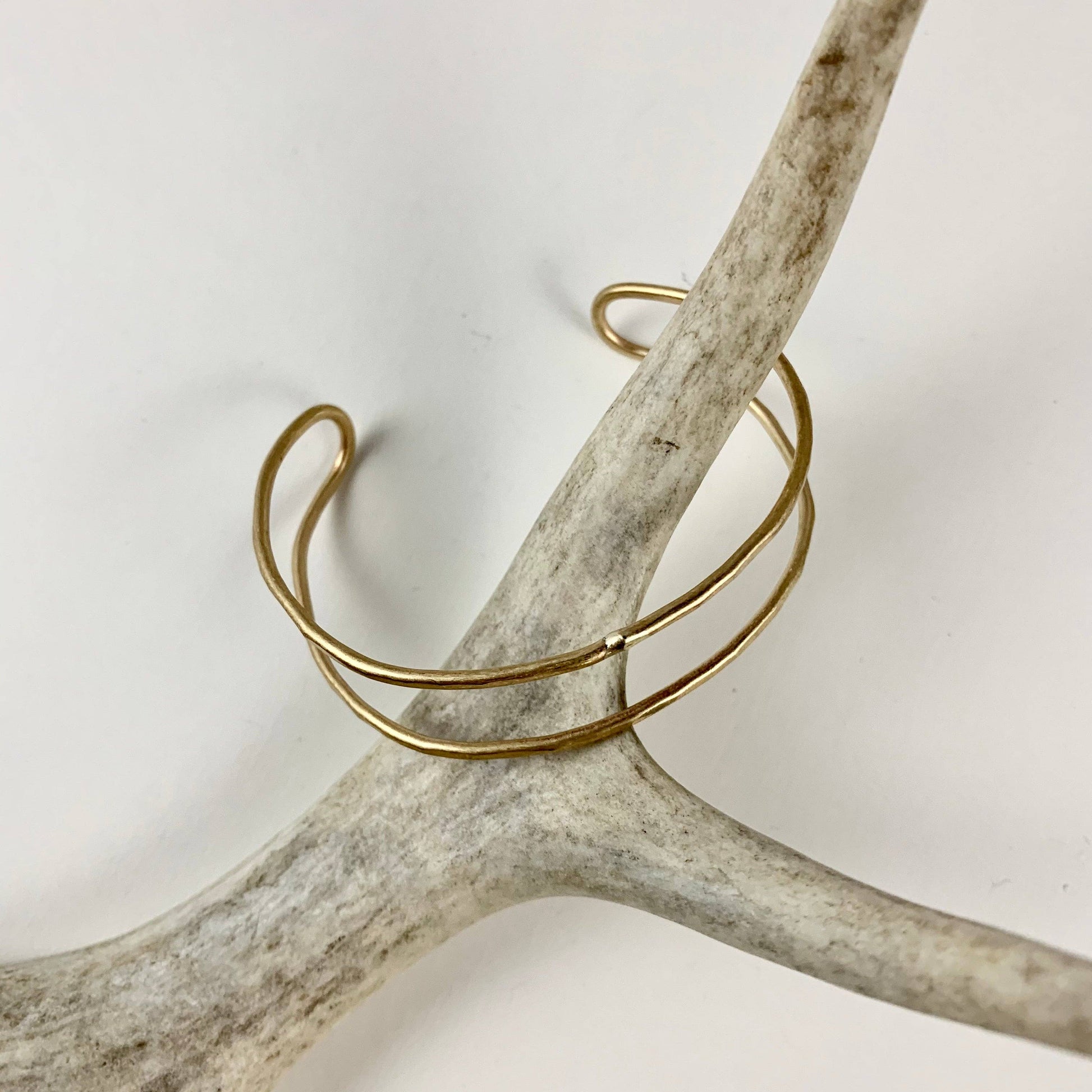 Handmade She-ra style cuff bracelet by Fluff Hardware featuring intricate metalwork and adjustable band design.