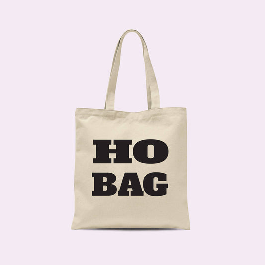 Crimson and Clover Studio Ho Bag Funny Tote Bag with card design, featuring vibrant colors and playful graphics.