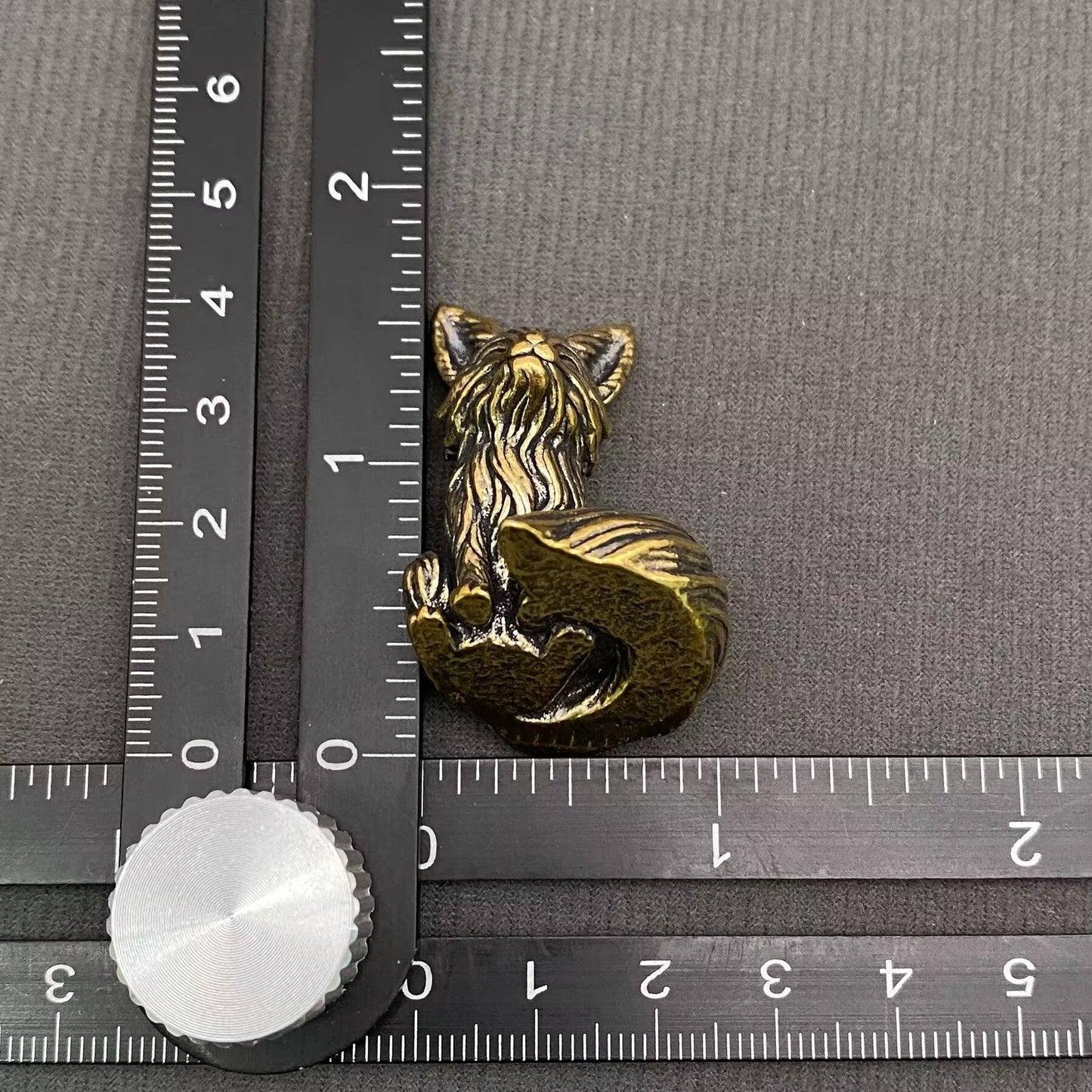 Brass Little Fox delights by Mio Queena, a detailed and shiny brass fox figurine with intricate features and a polished finish.