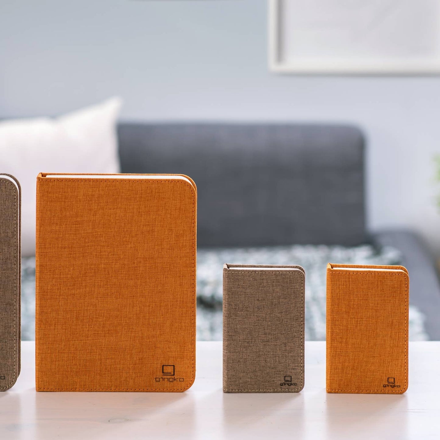 Gingko Design linen fabric smart book light lamp with adjustable arm and soft LED illumination on a wooden surface.