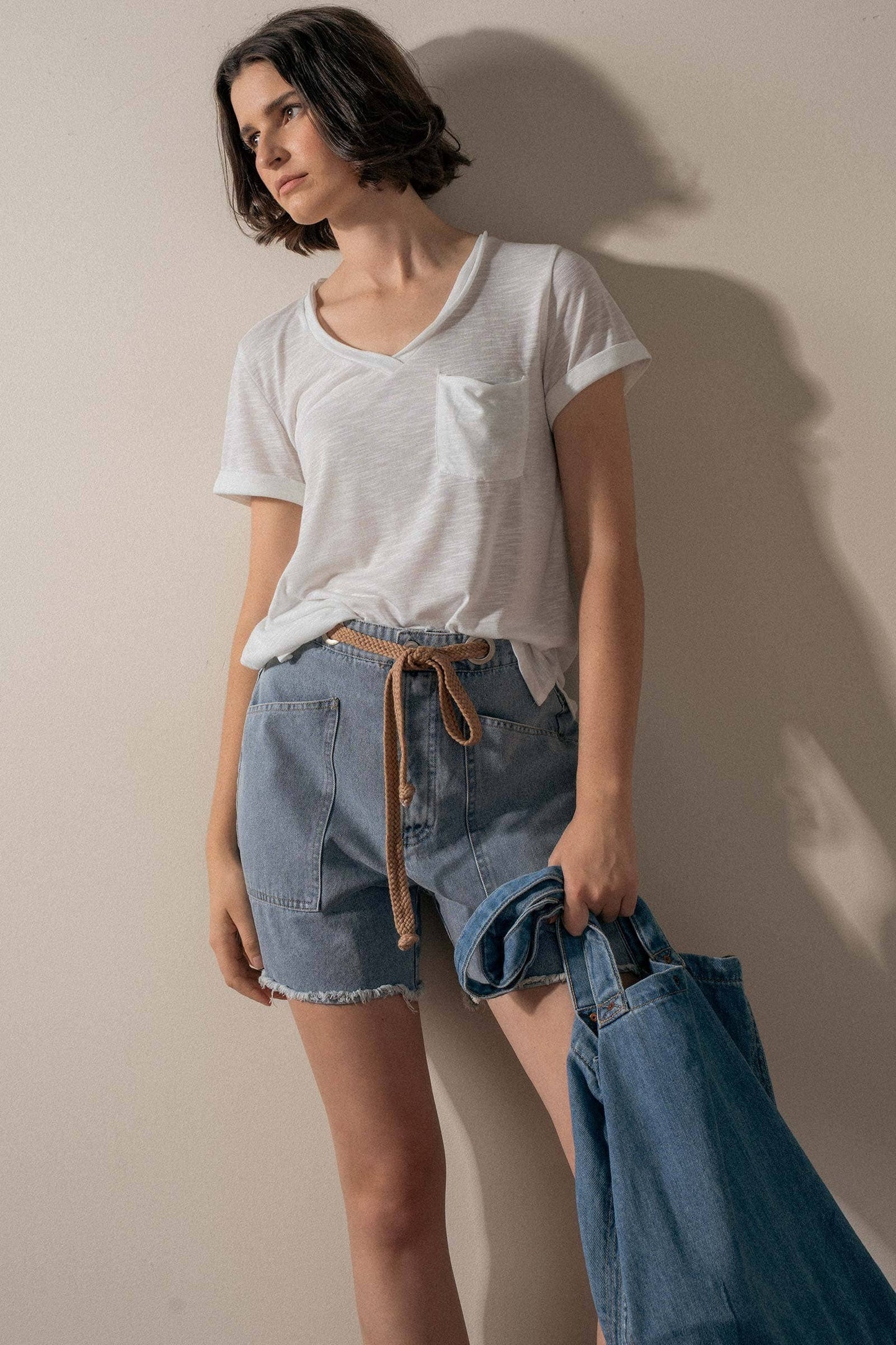 Urban Daizy high-waisted frayed hem denim shorts, front view showing distressed details and classic five-pocket design.