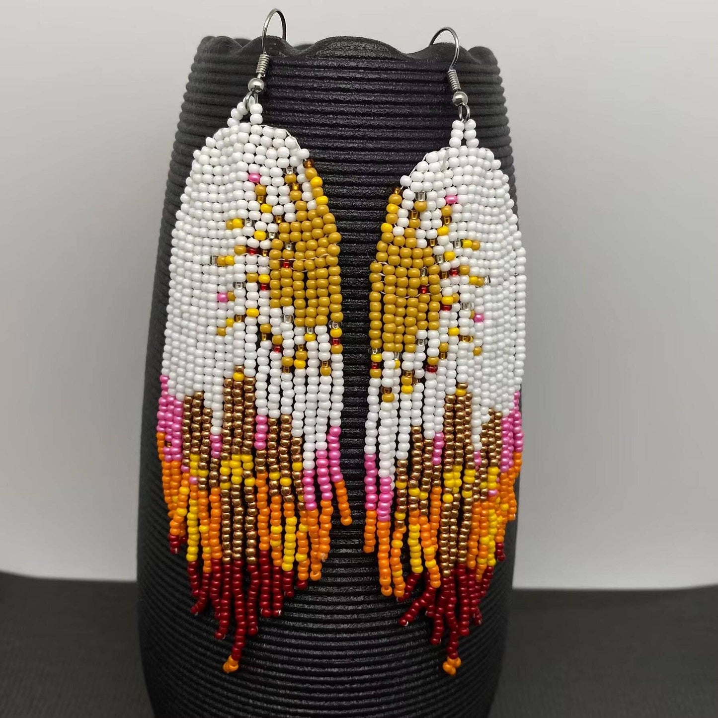 Hand-woven Sun Fringe Earrings by Mio Queena featuring intricate sun-shaped design and dangling fringe detail