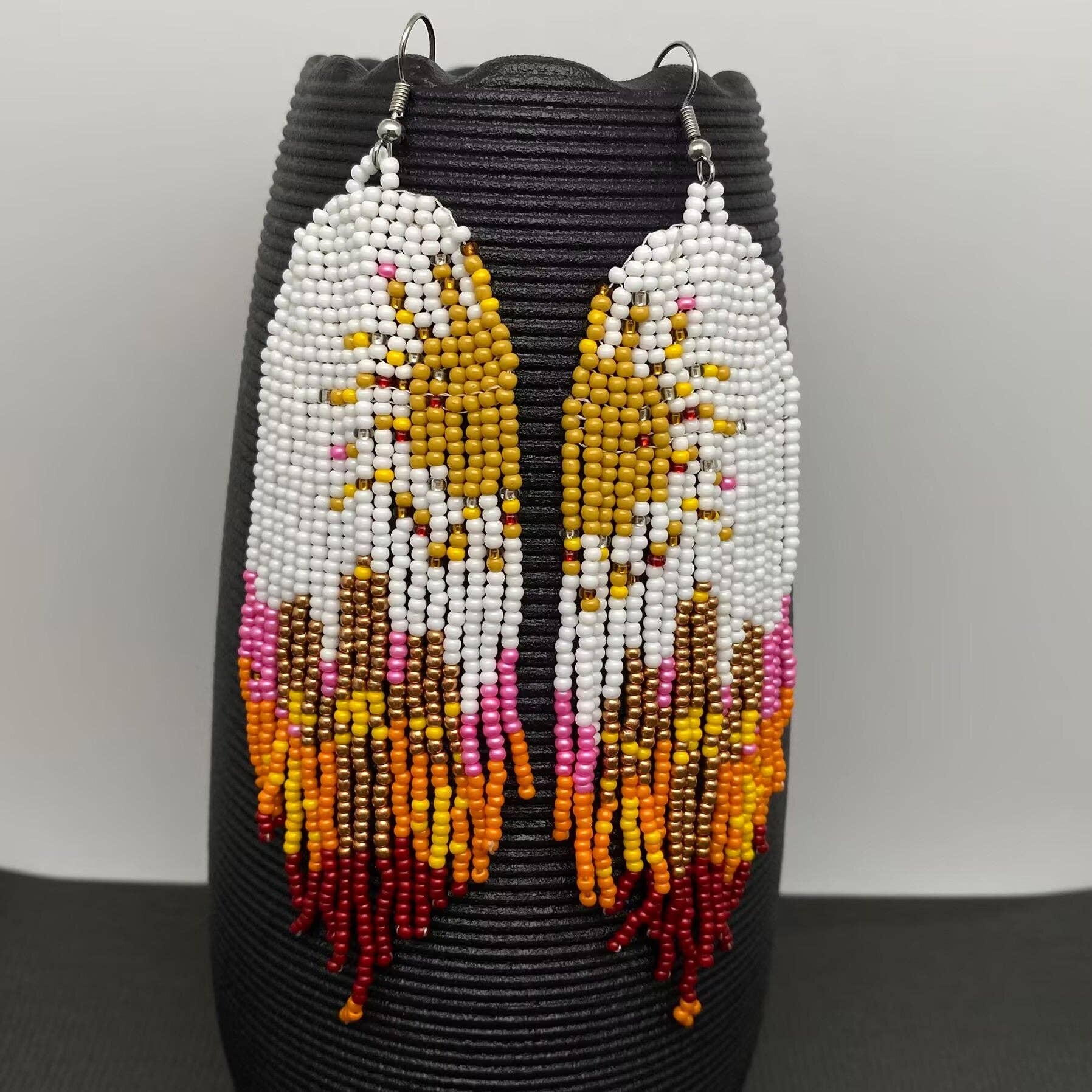 Hand-woven Sun Fringe Earrings by Mio Queena featuring intricate sun-shaped design and dangling fringe detail