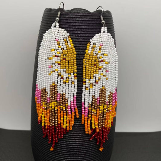 Hand-woven Sun Fringe Earrings by Mio Queena featuring intricate sun-shaped design and dangling fringe detail
