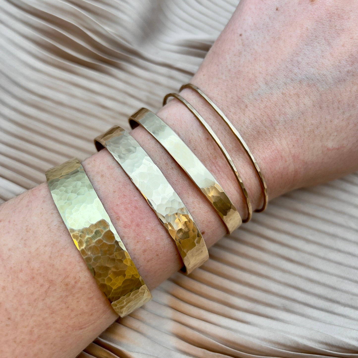 Handmade She-ra inspired bracelet cuffs by Fluff Hardware, featuring detailed metal craftsmanship and adjustable fit.