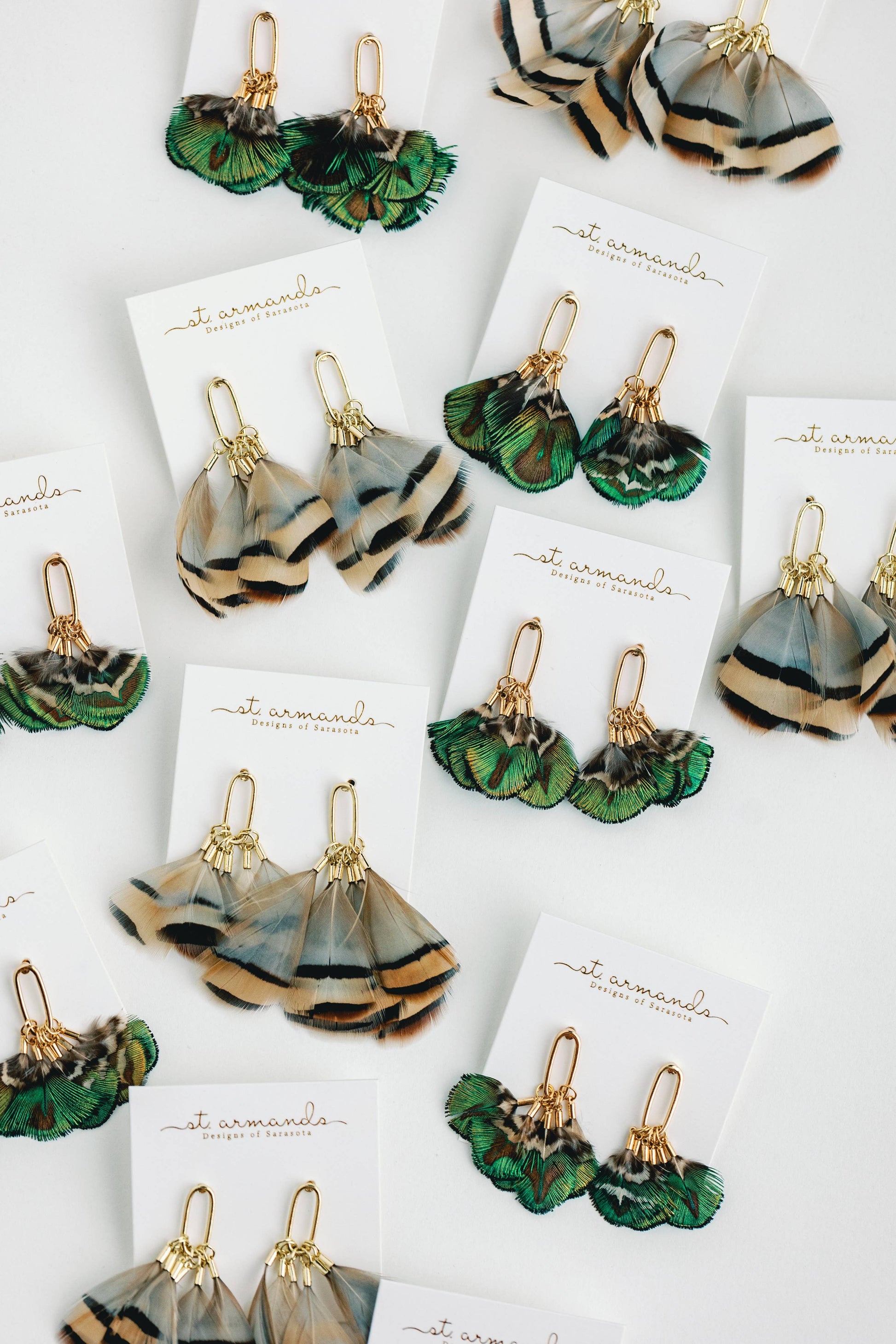 Mallard feather tassel earrings by St Armands Designs of Sarasota featuring natural feather tassels and elegant dangle style.