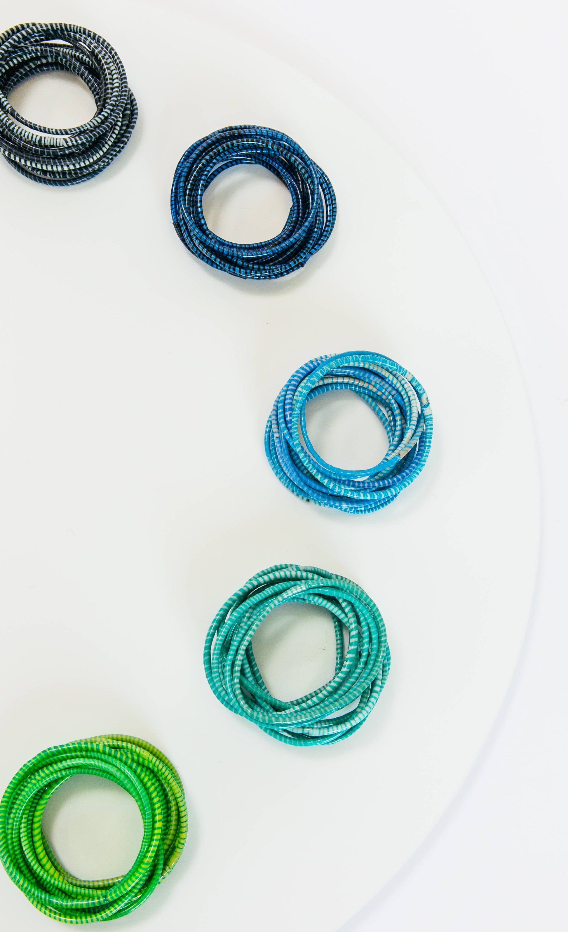 Black Beach Bangles bracelet by BECASA with multiple sleek, round bangles stacked together for a stylish beach accessory.