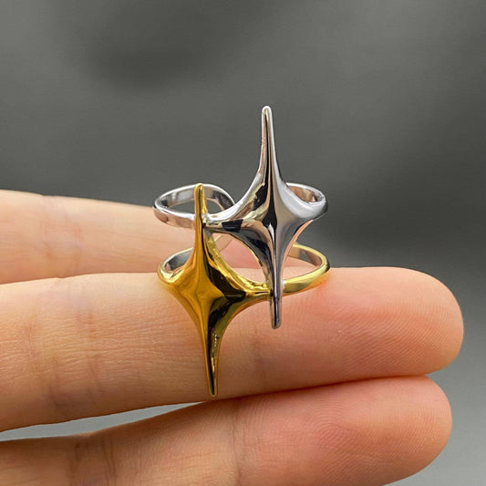 Two-tone double star ring by Mio Queena, featuring layered silver and gold-tone design with star motifs, on a white background.