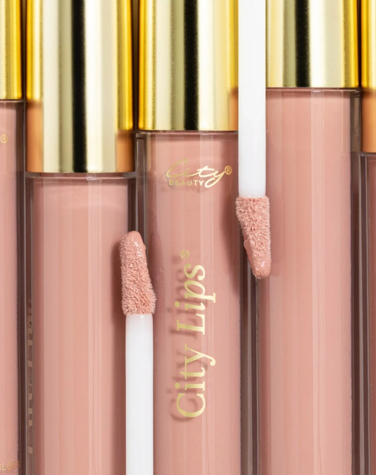 City Lips Pink Nude opaque lipgloss in clear tube, showcasing smooth, shiny finish and natural nude pink color on lips.