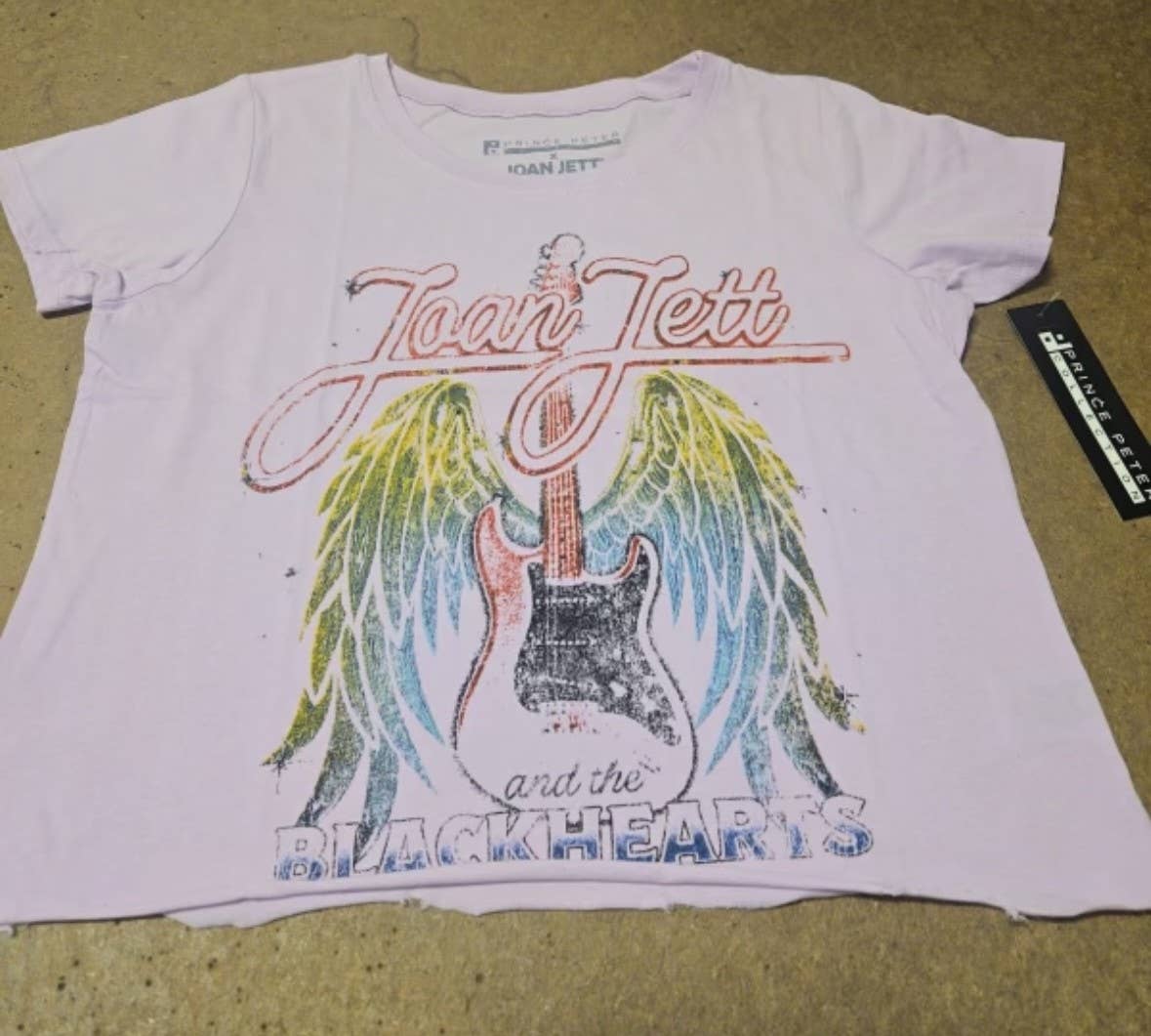 Prince Peter Collection Joan Jett Wings crop T-shirt featuring a graphic of wings and Joan Jett branding on the front.