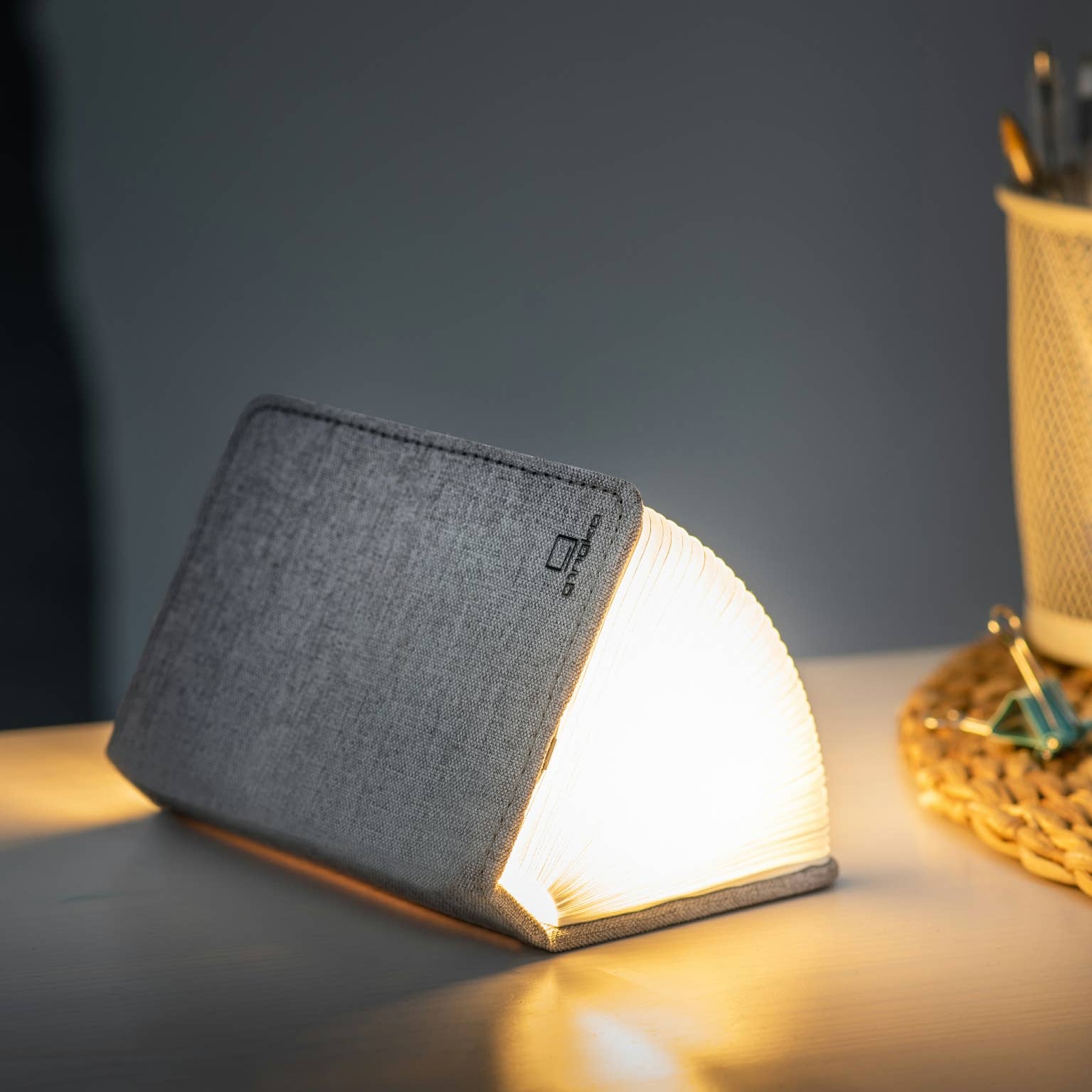 Gingko Design linen fabric smart book light lamp with soft LED illumination and elegant linen cover, designed for reading and ambiance.